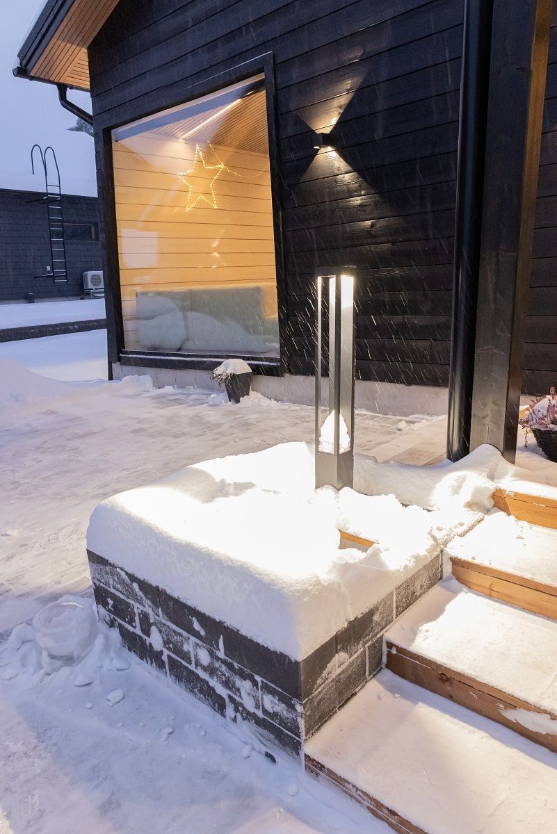 Outside, black Funk Pillar and Funk wall lights at the entrance bring light and style to the garden
